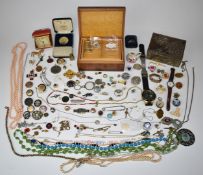 A collection of costume jewellery including vintage brooches, silver St Christopher, vintage watch