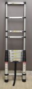 A telescopic portable aluminium ladder, height when collapsed 82cm