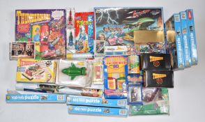 A collection of Thunderbirds related items including puzzles, alarm clock, crackers etc, most in
