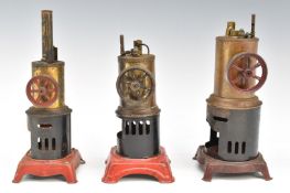 Three vertical live steam engines with through boiler crankshafts, two examples with whistles