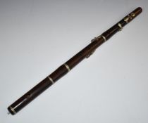 Rosewood flute with six holes and three keys, five sections with nickel joint rings, no visible