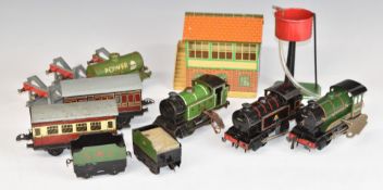 Twelve Hornby 0 gauge clockwork locomotives, rolling stock, buildings and accessories.