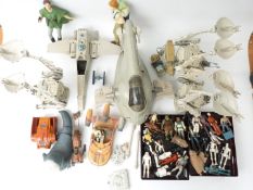 A collection of vintage and modern Star Wars figures and vehicles including Tie Interceptor, AT-