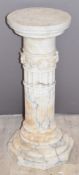 A stepped circular alabaster/marble jardinière stand with floral decoration in relief, diameter 29 x