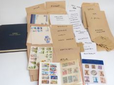 A collection of GB and world stamps and first day covers in envelopes, and a York stamp album
