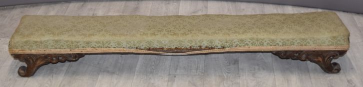 Low footstool raised on scrolling feet, length 120cm