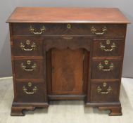 Georgian flame mahogany kneehole desk, fitted eight drawers, one a secret frieze drawer, and