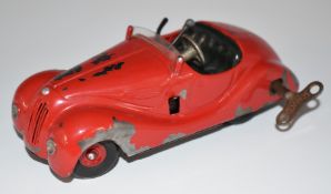 Schuco Auto clockwork tinplate car with red body and hubs, 4001.
