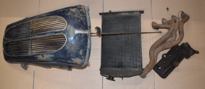 Ford Popular car grill, radiator core and a 1939 Ford 8 cylinder head and tubular manifold