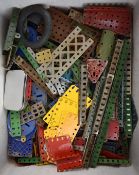 A collection of loose Meccano parts including nickel, blue and yellow pieces.
