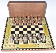 Ajedrez cast metal figural chess set in original box with ornate parquetry inlaid board.