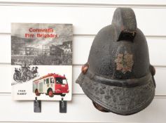 Cornwall Fire Brigade vintage helmet, and with a book relating to the brigade