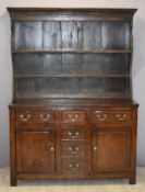 18th/19thC oak Welsh dresser with six drawers in a T shape and two cupboards, raised on simple