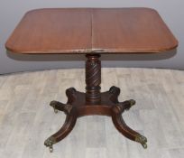 19thC mahogany fold-over card table with wrythen support raised on quartrefoil base with paw feet