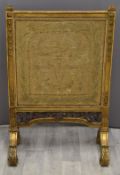 Regency carved gilt framed tapestry/embroidery fire screen raised on scroll feet, width 68 x