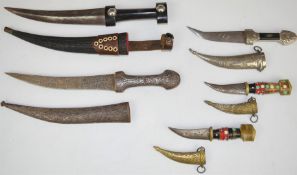 Five various Middle Eastern daggers, all with sheaths, longest blade 19cm. PLEASE NOTE ALL BLADED