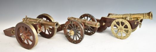 Three model cannon with brass or bronze barrels and wooden carriages, one with Royal Artillery or