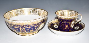 Chamberlains Worcester cabinet cup, saucer and slop bowl with gilt decoration in a navy ground,