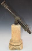 Bronze signalling cannon with star to barrel, on stone base with pivoted mount, length of barrel