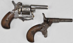 Two .22 blank firing pistols comprising a six-shot revolver with folding trigger and 1.75 inch
