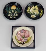 Three Moorcroft pin dishes with flower decoration, largest diameter 12cm