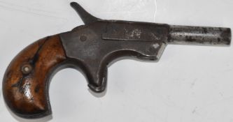 Derringer style hammer action pocket pistol with bulbous wooden grips, sheath trigger and 2.5 inch
