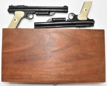 A pair of Crosman 130 .22 air pistols with monogrammed and chequered composite grips, serial numbers