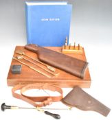 A collection of gun related accessories including detachable pistol shoulder stock, bullet