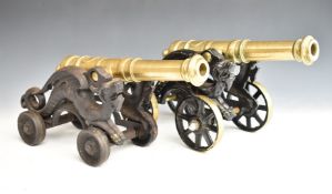 Two model brass cannon with dragon decoration to the four wheeled carriages, length of longer 48cm