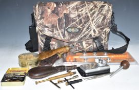 A collection of gun and shooting related items including two powder flasks with embossed