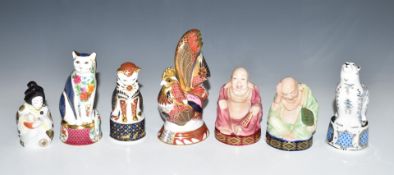 Seven Royal Worcester candle snuffers including Imari cockerel, smiling Buddha and Polar Bear,