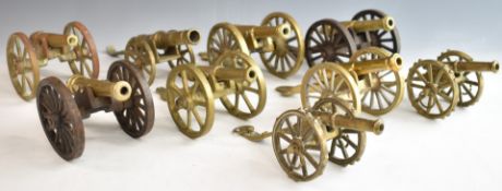 Nine mainly brass model cannon including a pair with cast iron carriages and wheels, length of