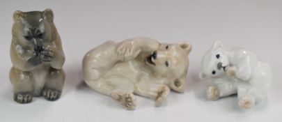 Three Royal Copenhagen models of bears comprising white rolling bear, brown bear eating and polar
