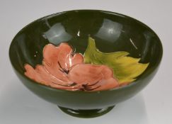 Moorcroft pedestal bowl decorated in the Hibiscus pattern on a green ground, H6.5 x D14cm
