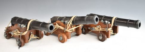 Three model cannon with wooden carriages and pulley and rope system, length 27.5cm