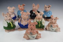 Collection of Wade Nat West pig money boxes, tallest 18cm