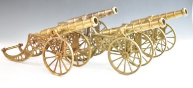 Four model cannon, one with silver plated finish, the others of brass construction, length 44cm