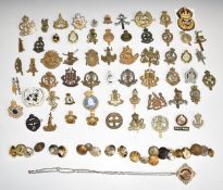 Approximately fifty metal military badges including Army Chaplain's Department, Military Provost