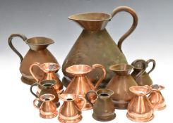 Graduated set of six copper measuring jugs from 2 gallon to half pint, together with six further