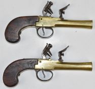 A pair of unnamed flintlock pocket pistols each with brass body, engraved locks, steel trigger