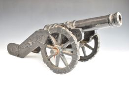 Cast iron model cannon with coat of arms to barrel, overall length 72cm