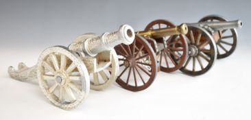 Three model cannon including one with wooden wheels and bucket below, another marked Dahlgren