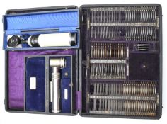 19th or early 20thC cased set of opticians lenses, with tooled leather titles and leather cover to