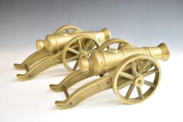 Pair of model cannon of brass construction, the star to top of barrels, overall length 34cm