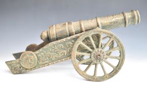 Bronze or similar model cannon with lion mask to front, overall length 61.5cm