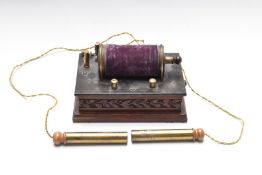 Electric shock therapy machine, on carved wooden base, length 20cm