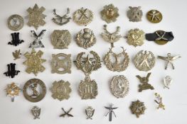 Approximately thirty Scottish and Gurkha metal hat badges including Cameron's, Black Watch,