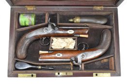 A pair of Harvey & Son of Exeter percussion hammer action pistols each with named and engraved lock,