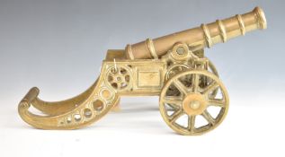 A model desk or signalling cannon with 11 inch graduated brass barrel on brass carriage, overall