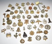 Approximately fifty British Infantry metal cap badges including East Surrey Regiment, Bedfordshire